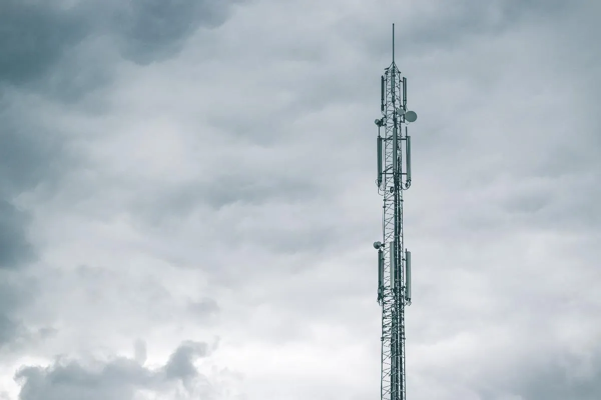 A telecommunications mast against a cloudy sky.