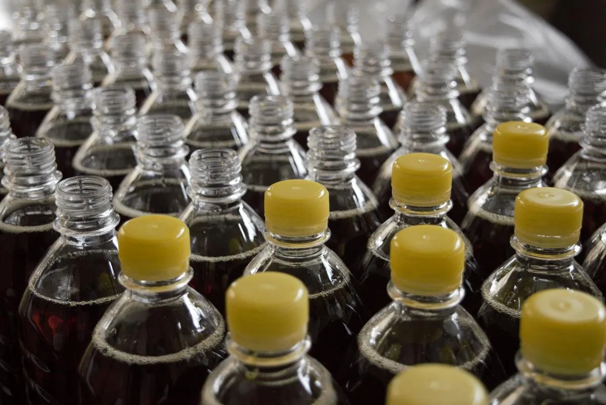 Rows of capped bottles on a production line.