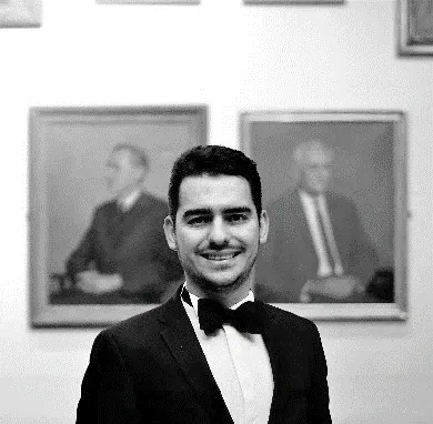 Portrait of a man in a bow tie and dinner jacket.